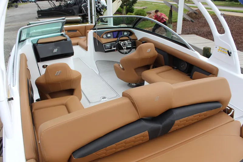 Slide: The Image of 2025 Four Winns HD3 OB boat interior with tan leather seating and modern dashboard. - 9