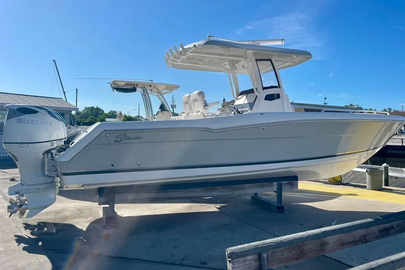 Slide: The Image of 2021 Stamas 31 Adventura boat with Suzuki engine on display at marina. - 2