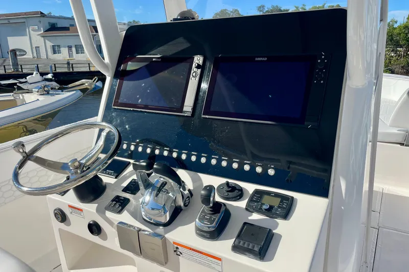Slide: The Image of Control panel of 2021 Stamas 31 Adventura boat with dual screens and steering wheel. - 6