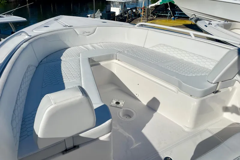 Slide: The Image of 2021 Stamas 31 Adventura boat with white seating and hexagonal pattern, docked by the water. - 8