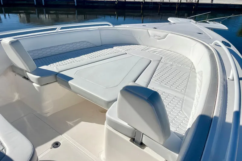 Slide: The Image of 2021 Stamas 31 Adventura boat with spacious, cushioned seating area on deck. - 9