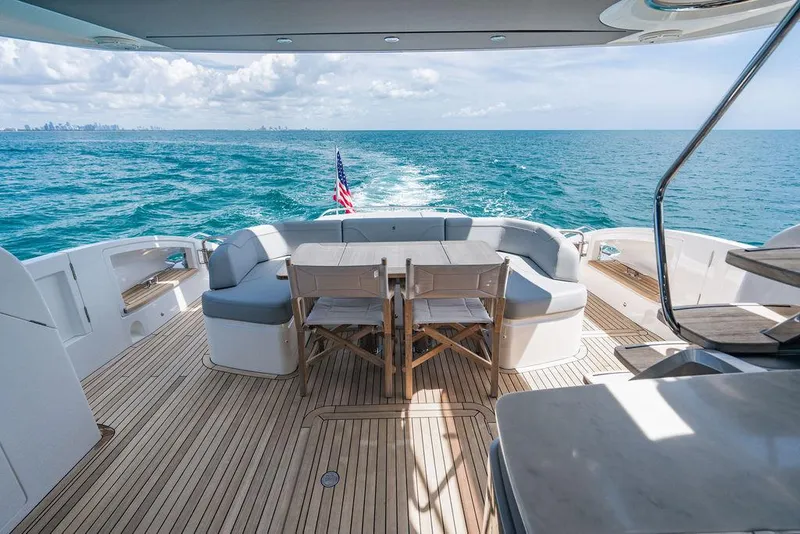 Slide: The Image of Luxurious 2021 Princess S62 yacht deck with seating, ocean view, and American flag. - 10
