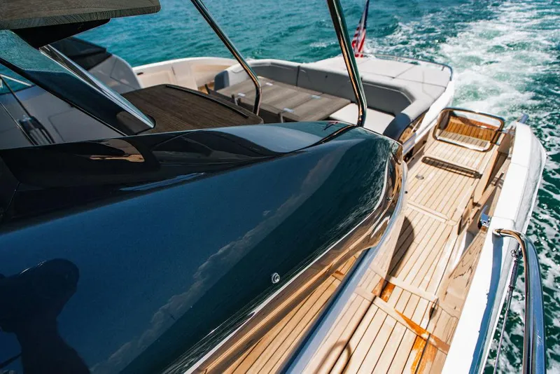 Slide: The Image of Luxury Princess S62 yacht deck with teak flooring, cruising on blue ocean waters, 2021 model. - 28
