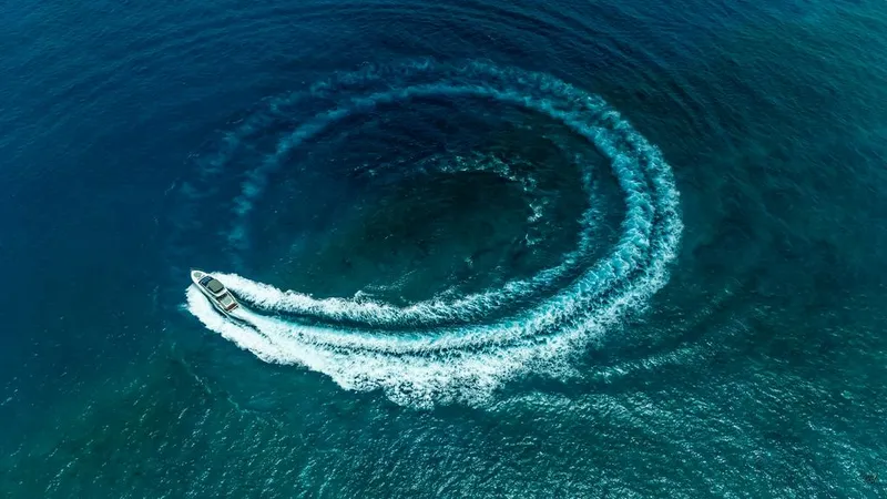 Slide: The Image of Aerial view of 2021 Princess S62 yacht creating circular wake in deep blue ocean. - 3