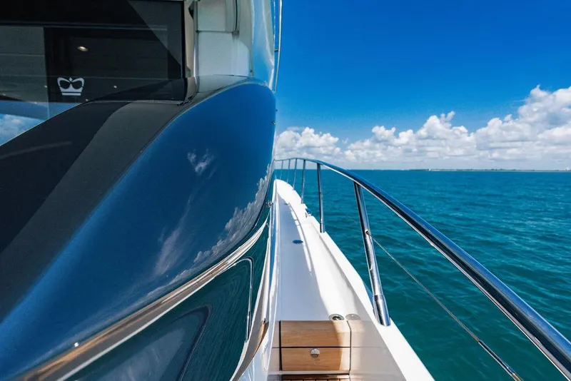 Slide: The Image of Sleek 2021 Princess S62 yacht cruising on clear blue ocean under a bright sky. - 30