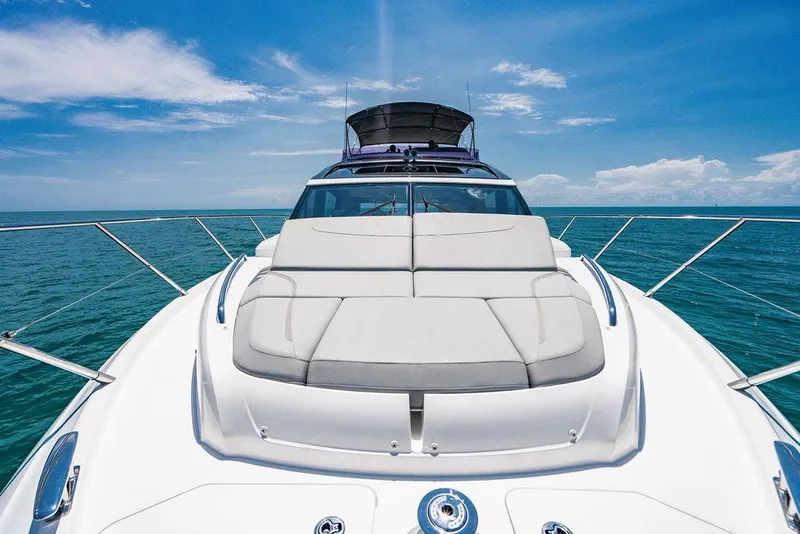 Slide: The Image of Luxury Princess S62 yacht on open sea, showcasing sleek design and sunbathing area. - 33
