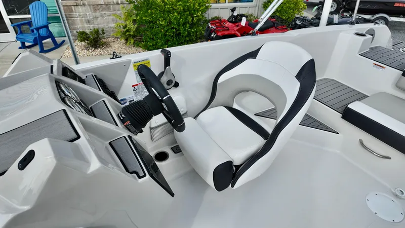 Slide: The Image of 2026 Starcraft SVX 211 OB boat cockpit with steering wheel and comfortable seating. - 10