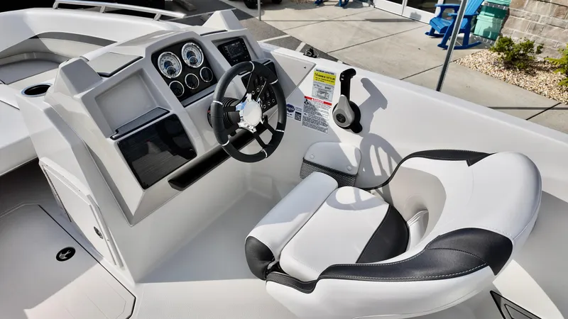 Slide: The Image of 2026 Starcraft SVX 211 OB boat cockpit with steering wheel and gauges. - 11