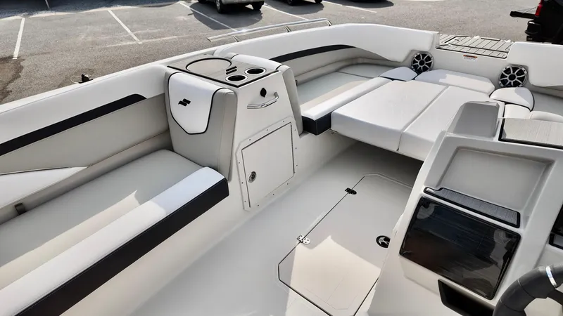 Slide: The Image of 2026 Starcraft SVX 211 OB boat interior with white seating and cup holders. - 13