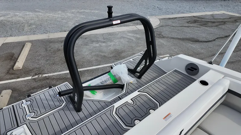 Slide: The Image of 2026 Starcraft SVX 211 OB boat deck with black wakeboard tower and gray flooring. - 15