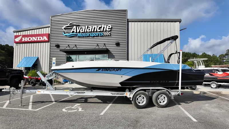 The Image of 2026 Starcraft SVX 211 OB boat on trailer at Avalanche Motorsports dealership. - 2