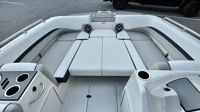Slide: The Image of 2026 Starcraft SVX 211 OB boat interior with white seating and cup holders. - 7