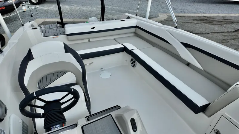 Slide: The Image of 2026 Starcraft SVX 211 OB boat interior with sleek seating and modern steering wheel. - 8