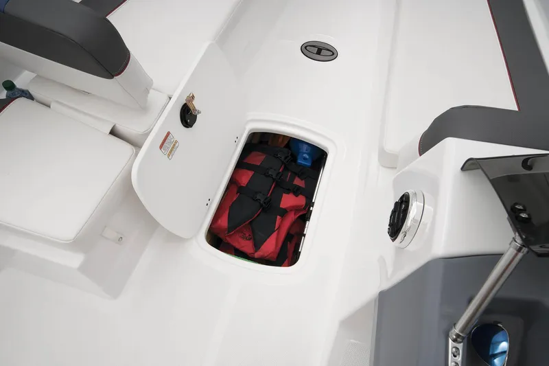 Slide: The Image of 2023 Tahoe T18 boat storage compartment with life jacket and gear. - 38