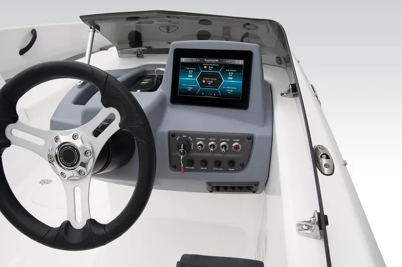Slide: The Image of 2023 Tahoe T18 boat dashboard with steering wheel and digital display. - 39