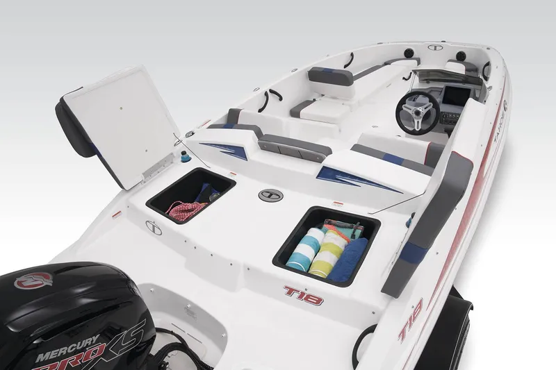 Slide: The Image of 2023 Tahoe T18 boat interior with storage compartments and Mercury engine. - 49