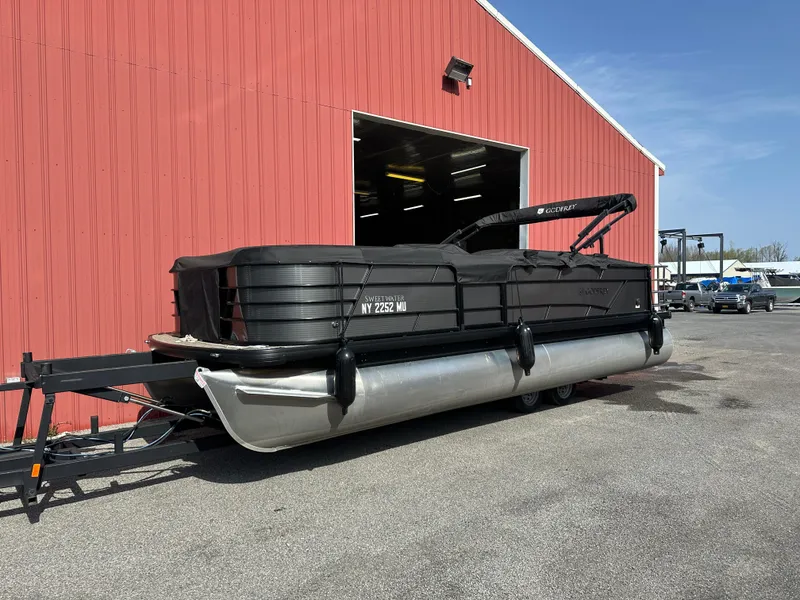 The Image of 2023 Godfrey SWEETWATER 2286 SFL pontoon boat parked outside red building. - 12