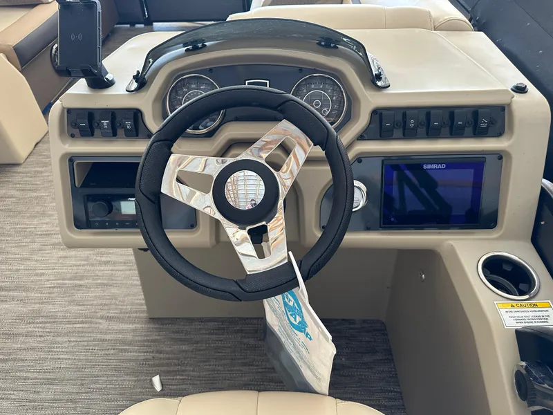 Slide: The Image of 2023 Godfrey SWEETWATER 2286 SFL boat dashboard with steering wheel and control panel. - 16