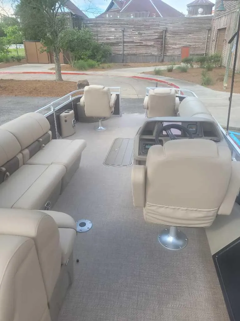 Slide: The Image of 2025 Sun Tracker Sportfish 24 XP3 pontoon boat interior with beige seating. - 3