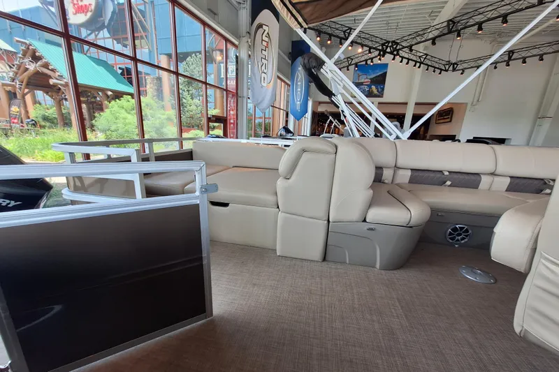Slide: The Image of 2025 Sun Tracker Sportfish 24 XP3 pontoon boat interior with beige seating and modern design. - 10