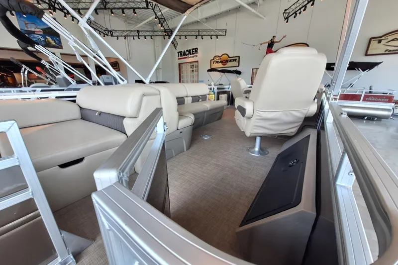 Slide: The Image of 2025 Sun Tracker Sportfish 24 XP3 interior with plush seating in showroom. - 3