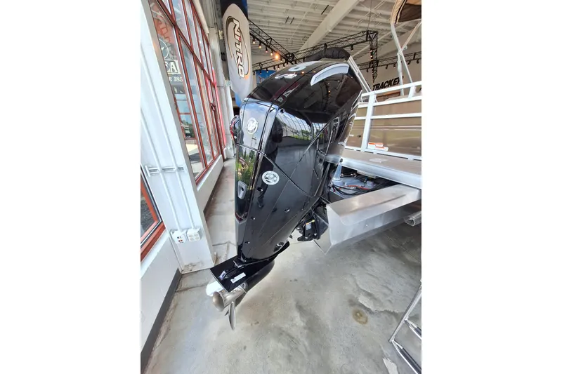 Slide: The Image of 2025 Sun Tracker Sportfish 24 XP3 boat engine in showroom display. - 6