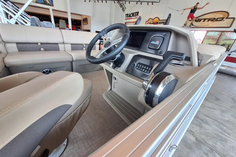 Slide: The Image of 2025 Sun Tracker Sportfish 24 XP3 boat interior with steering console and seating. - 4