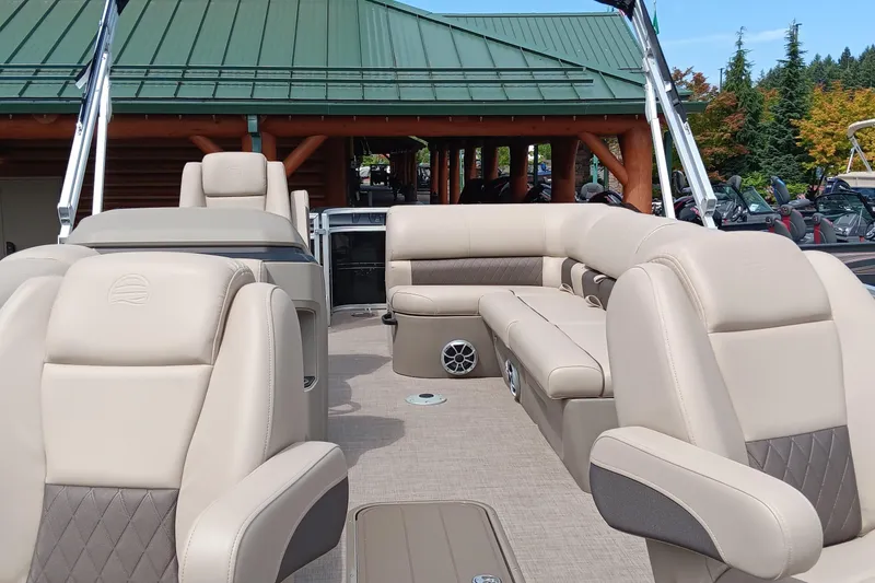 Slide: The Image of 2025 Sun Tracker Sportfish 24 XP3 interior with beige seating and modern design. - 4