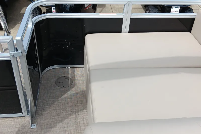 Slide: The Image of 2025 Sun Tracker Sportfish 24 XP3 interior with beige seating and metal railing. - 7