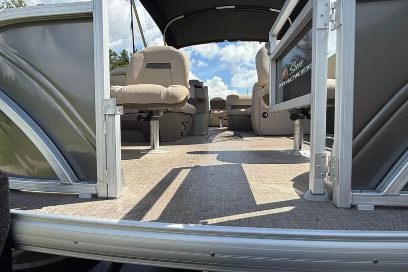 Slide: The Image of 2025 Sun Tracker Fishin' Barge 22 XP3 interior with seating and open deck view. - 72
