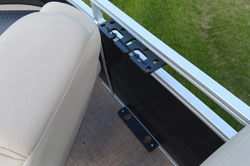Slide: The Image of 2025 Sun Tracker Sportfish 24 XP3 interior detail with beige seating and metal railing. - 13