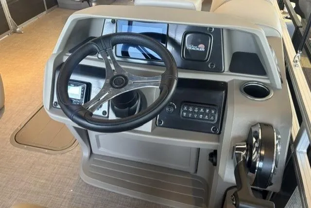 Slide: The Image of 2025 Sun Tracker Fishin' Barge 22 XP3 dashboard with steering wheel and controls. - 5