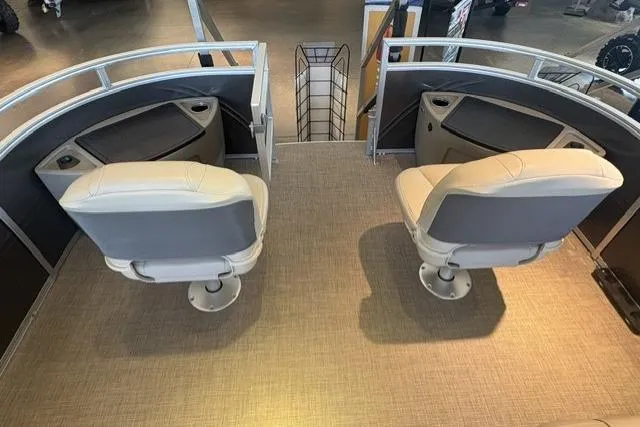 Slide: The Image of 2025 Sun Tracker Fishin' Barge 22 XP3 interior with two swivel seats and cup holders. - 2