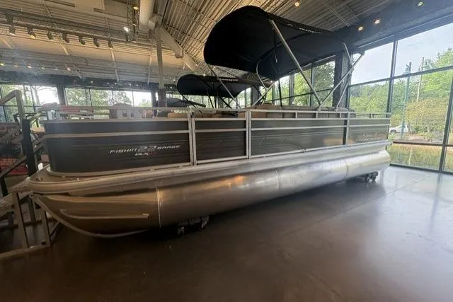 The Image of 2025 Sun Tracker Fishin' Barge 22 XP3 pontoon boat displayed indoors. - 0