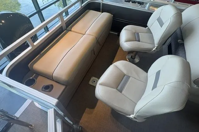Slide: The Image of Interior of 2025 Sun Tracker Fishin' Barge 22 XP3 with comfortable seating and cup holders. - 7