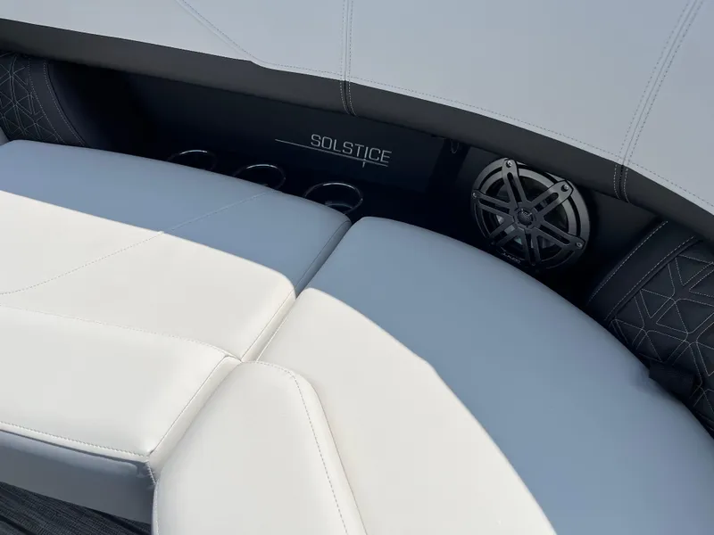 Slide: The Image of 2026 Harris Solstice 230 boat interior with white seating and speaker system. - 12