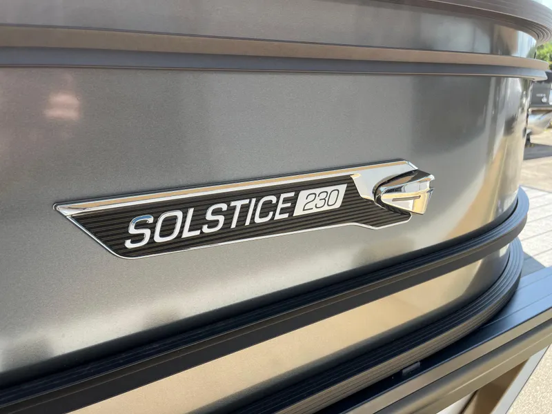Slide: The Image of 2026 Harris Solstice 230 boat emblem on metallic surface. - 13
