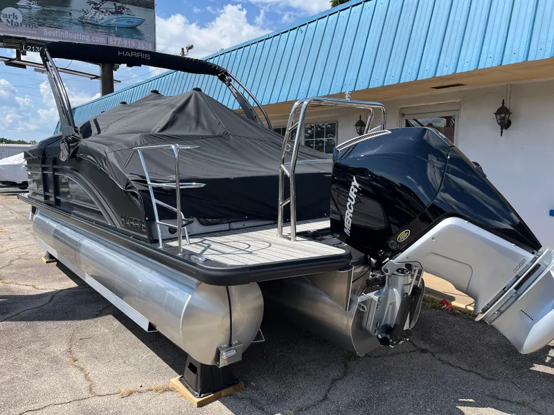 Slide: The Image of 2026 Harris Solstice 230 pontoon boat with Mercury outboard motor, covered and docked. - 3