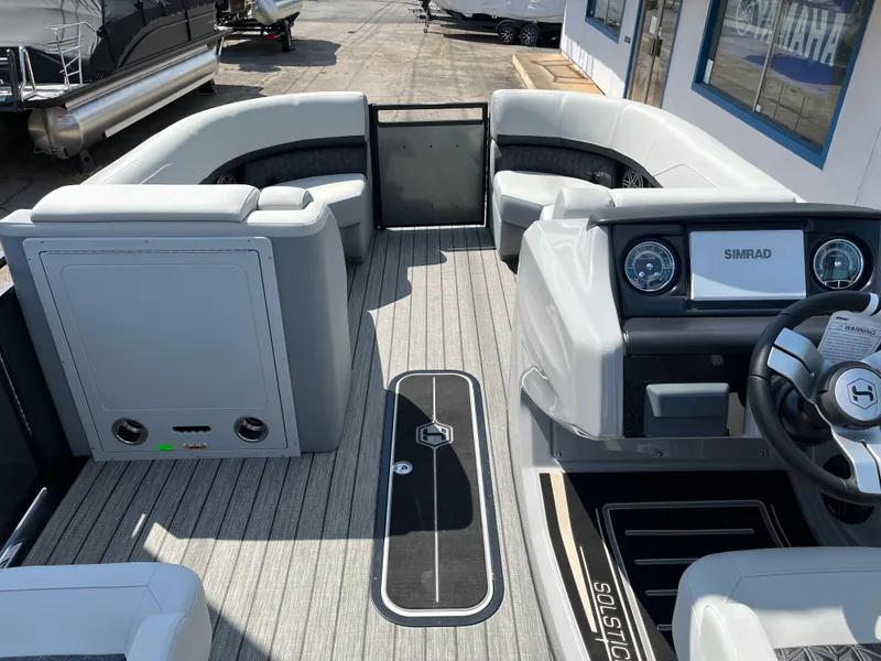 Slide: The Image of 2026 Harris Solstice 230 boat interior with modern dashboard and seating. - 6