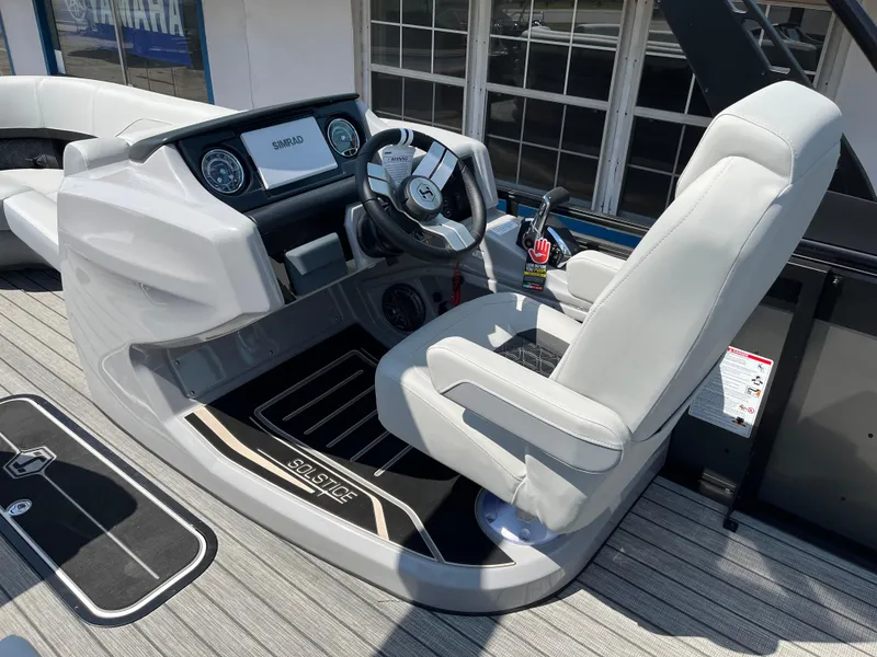 Slide: The Image of 2026 Harris Solstice 230 boat cockpit with modern steering and controls. - 9