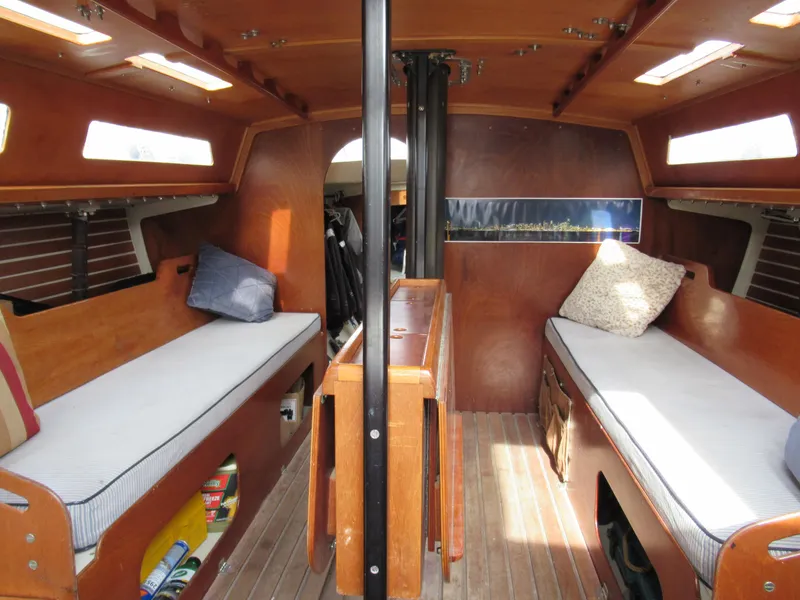 Slide: The Image of Interior of 1984 Santa Cruz 50 sailboat with wooden furnishings and cozy seating. - 12