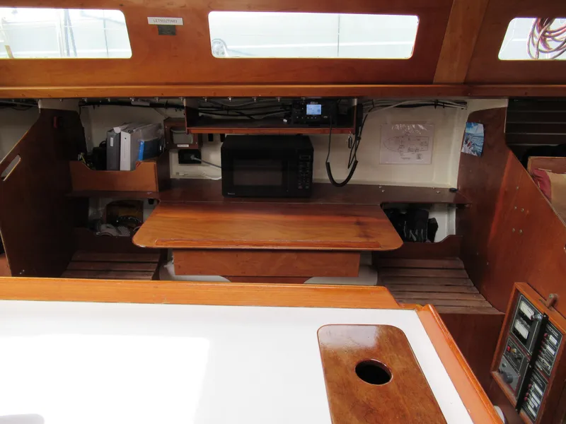 Slide: The Image of Interior of 1984 Santa Cruz 50 sailboat with wooden cabinetry and microwave. - 15