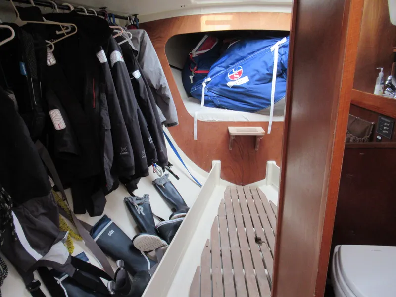 Slide: The Image of Interior of 1984 Santa Cruz 50 sailboat with hanging jackets and boots. - 17
