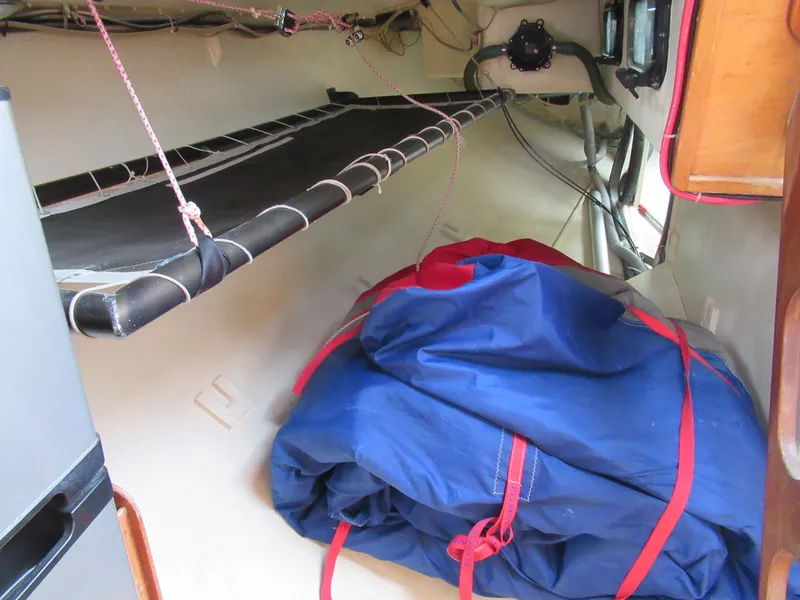 Slide: The Image of Interior of 1984 Santa Cruz 50 sailboat with blue sail storage and bunk. - 18