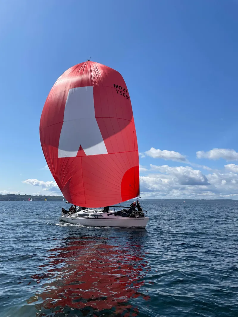 Slide: The Image of Sailboat with red spinnaker on open water, Santa Cruz 50, 1984 model. - 2