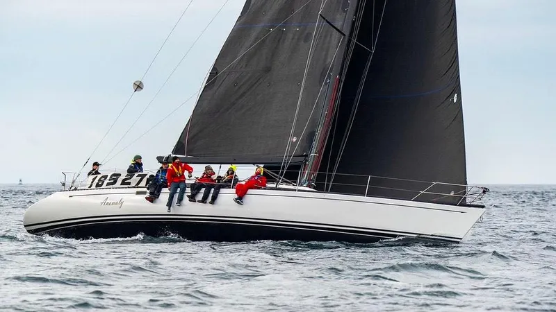 Slide: The Image of Sailing yacht Santa Cruz 50 from 1984 with crew on deck, navigating ocean waters. - 3