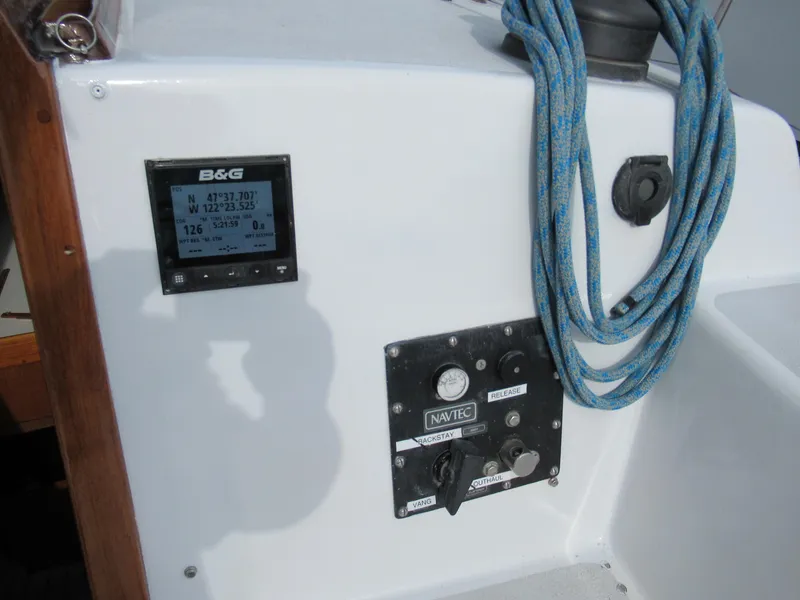 Slide: The Image of Control panel on a 1984 Santa Cruz 50 sailboat with navigation instruments and coiled rope. - 8