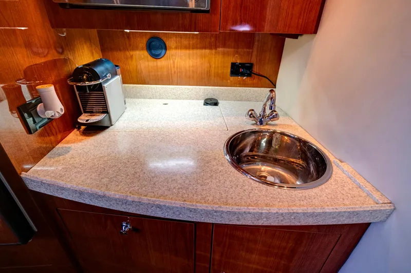 Slide: The Image of 2006 Regal 3560 COMMODORE yacht kitchenette with sink and coffee maker. - 23