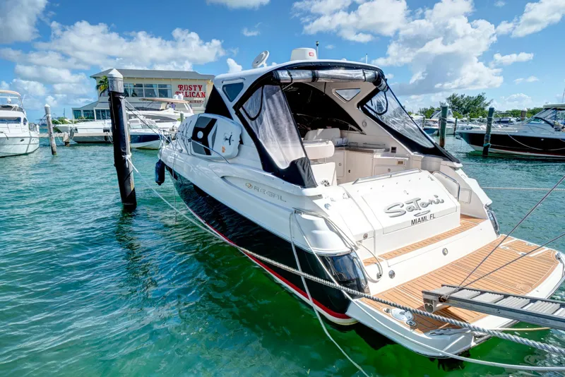 Slide: The Image of 2006 Regal 3560 COMMODORE yacht docked in sunny marina with clear blue skies. - 3