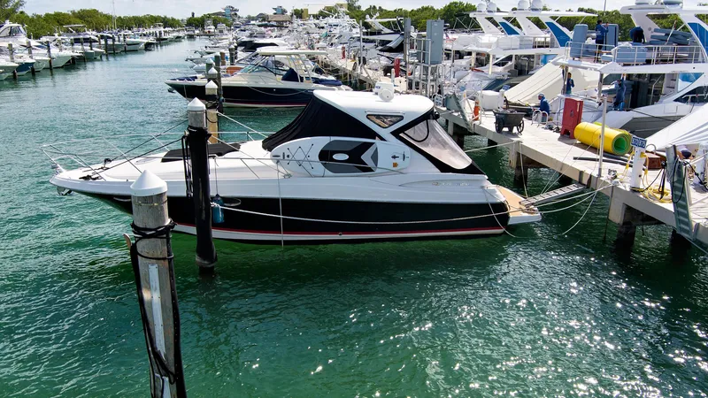 Slide: The Image of 2006 Regal 3560 COMMODORE yacht docked at a marina with clear green water. - 5